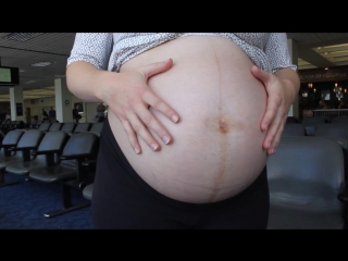 pregnant woman waiting on a flight